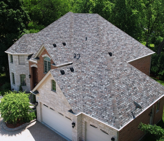 Drone view of replaced roof on a large brick home courtesy of 3JM Exteriors